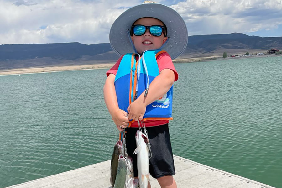 Youngster holding several caught fish at Otter Creek