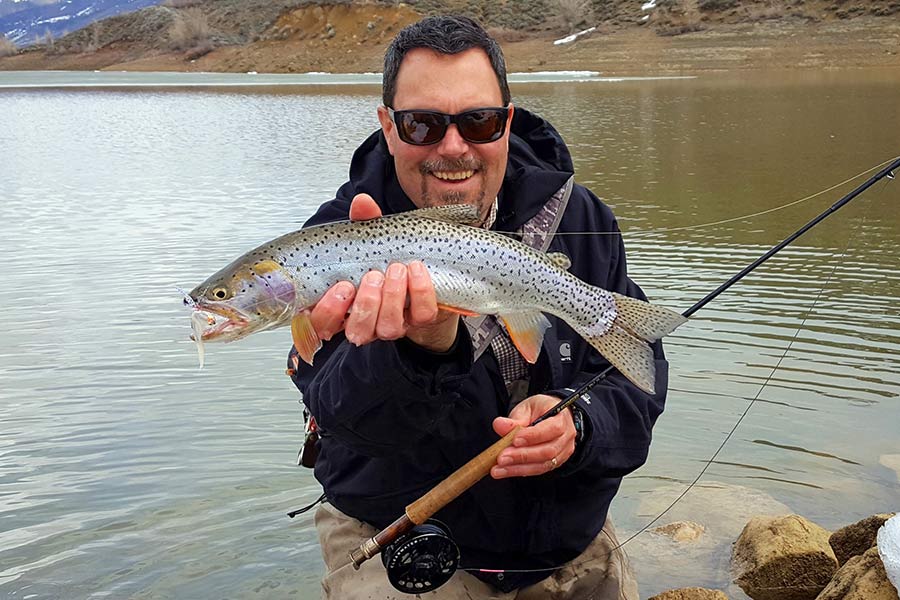 Angler holding a 19-inch Bonneville cutthroat trout caught at Lost Creek Reeservoir