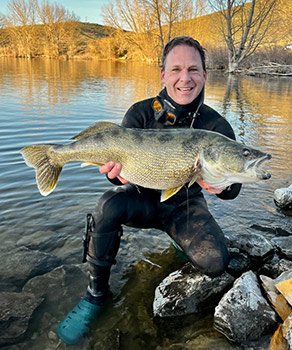 Steven Gottfredson holding a record-sized walleye fish, caught at Deer Creek Reservoir in April 2024