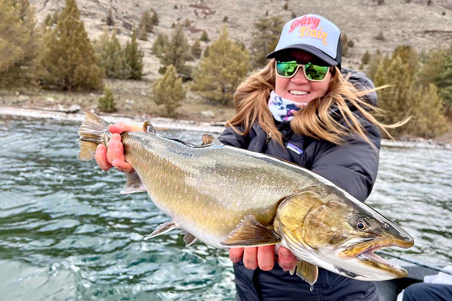 Heidi Lewis holding a caught cutthroat trout