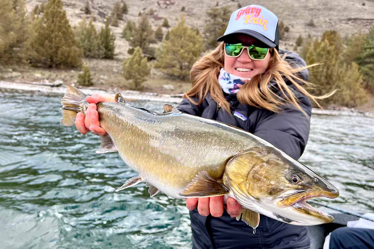 Heidi Lewis holding a fish in the water