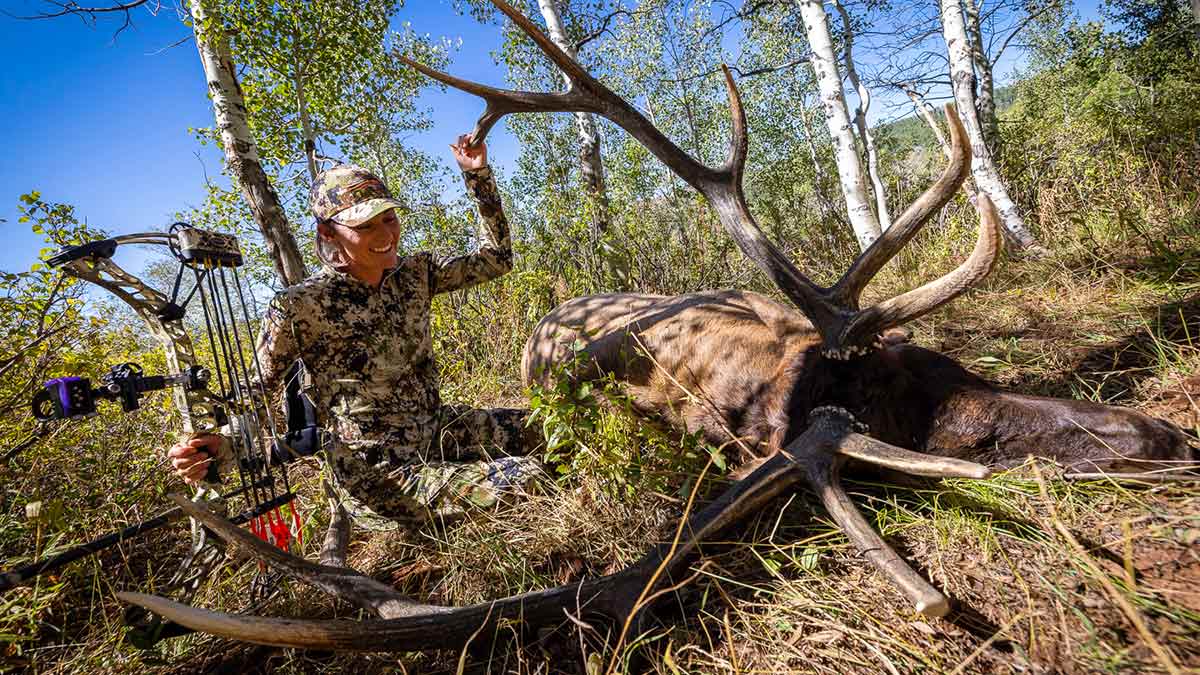 Lindsey Browne Davis standing over harvested big game