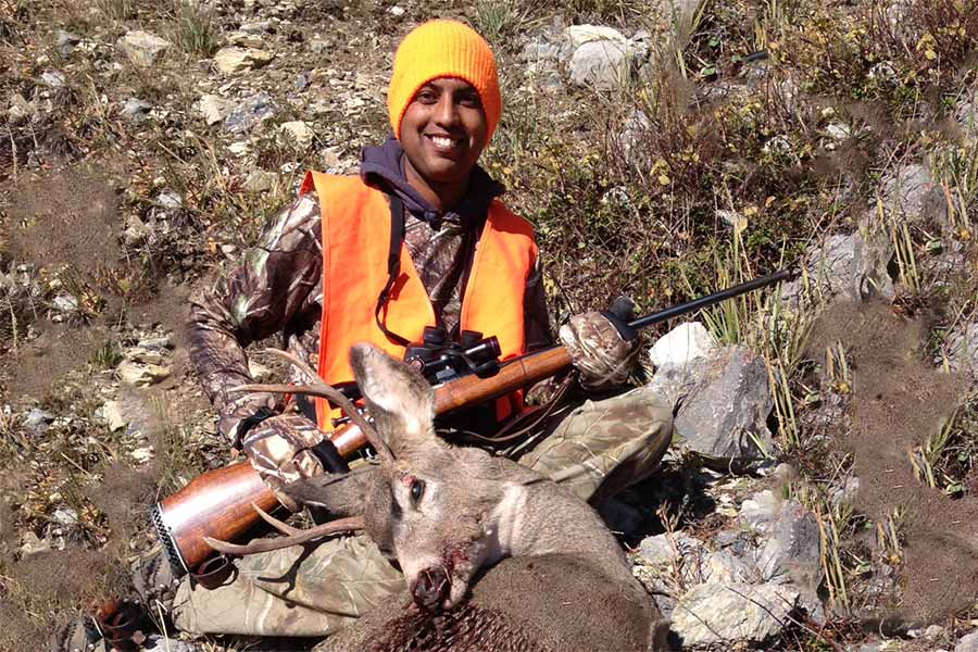 Luke Simon in hunter orange with harvested big game